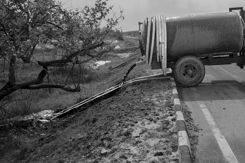 Blackwater from a septic tank emptied into a fruit orchard outside Hansi town, Hisar district, Haryana